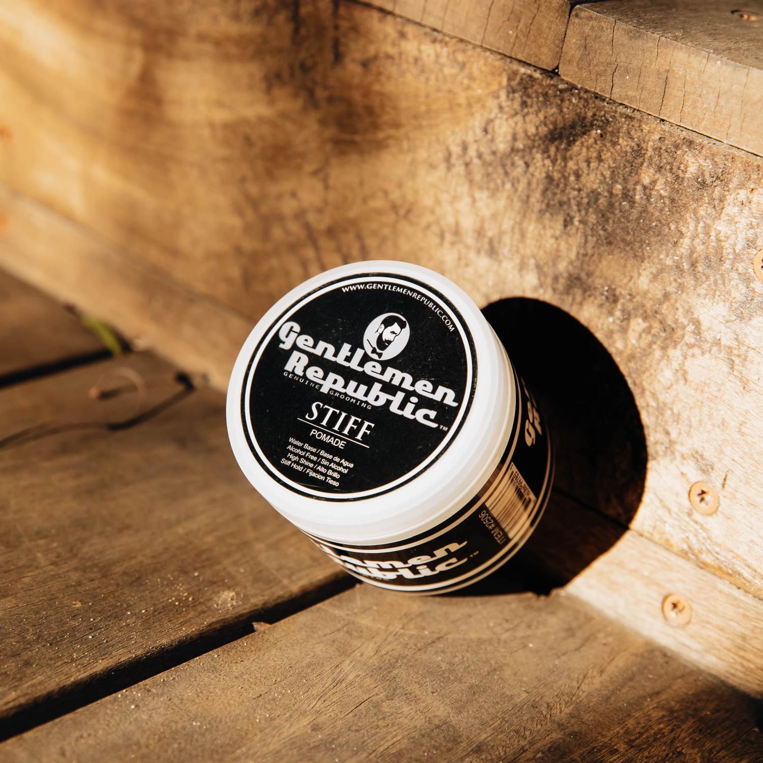 Stiff Hair Pomade - Achieve a stiff hold and high shine with this water-based pomade designed for thick hair. Displayed on rustic wooden steps, it rinses clean and provides all-day control for modern gentleman styles. Made in the USA without beeswax or artificial colors, it features a light weight and pleasant fragrance. Ingredients include water, glycerin, and a blend of natural extracts and polymers for superior styling.